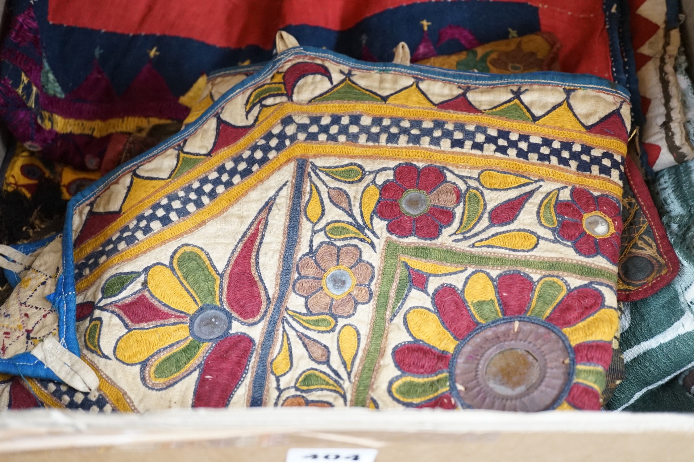 A collection of Indian mirrored worked hangings, a length of batik fabric and a woven shawl